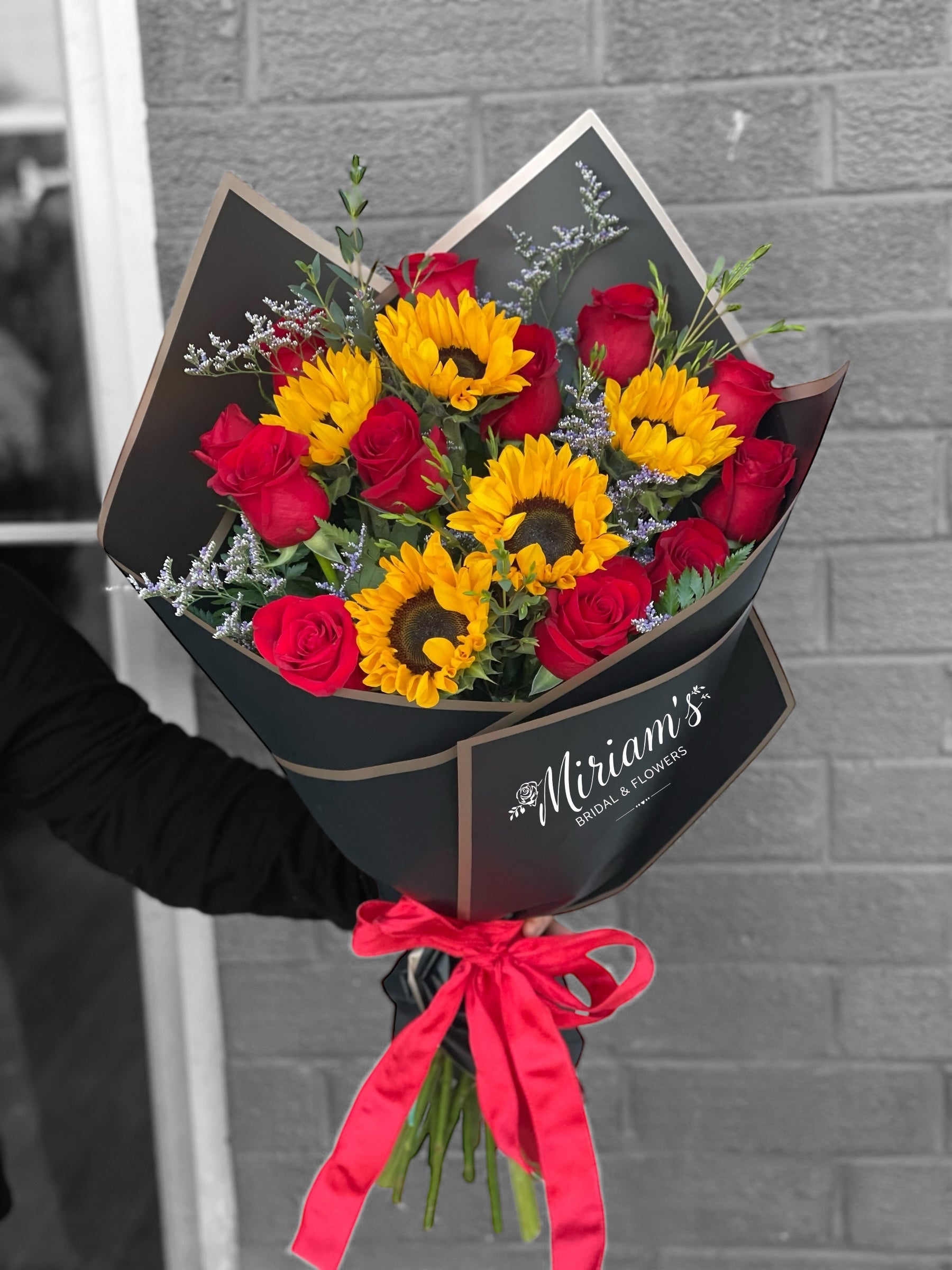 Dozen Roses and 5 Sunflowers Wrapped bouquet – Miriam's Bridal and